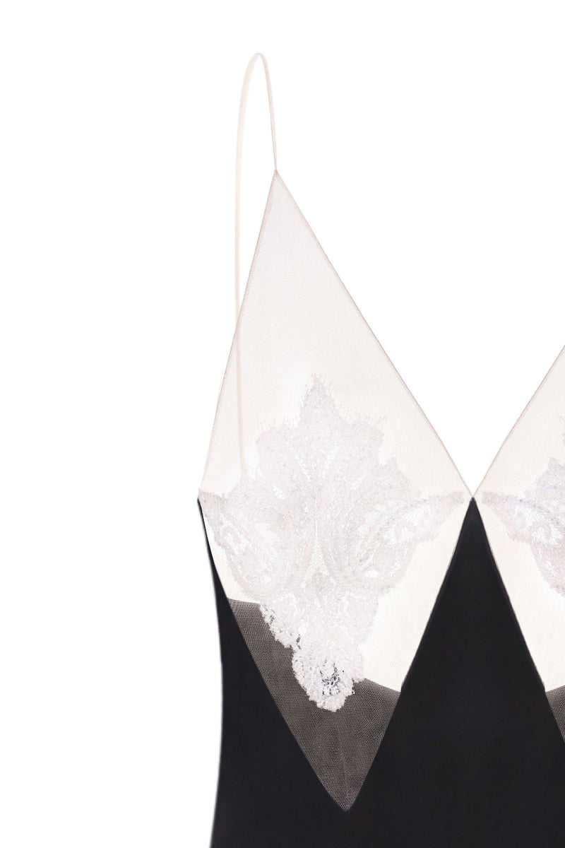 Nué Perla black maxi dress displayed on a hanger, showcasing its elegant flowy fabric and stylish design.