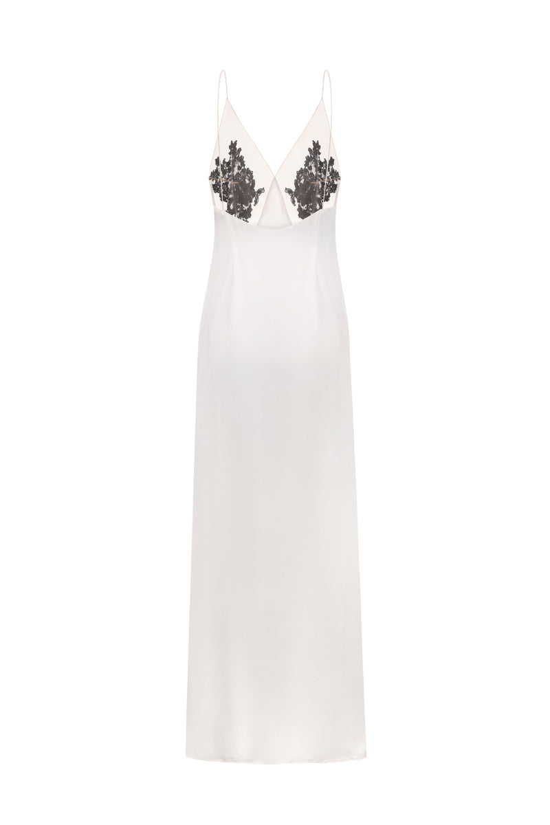 Nué Perla white maxi dress displayed on a hanger, showcasing elegant flowing fabric and effortless summer style.