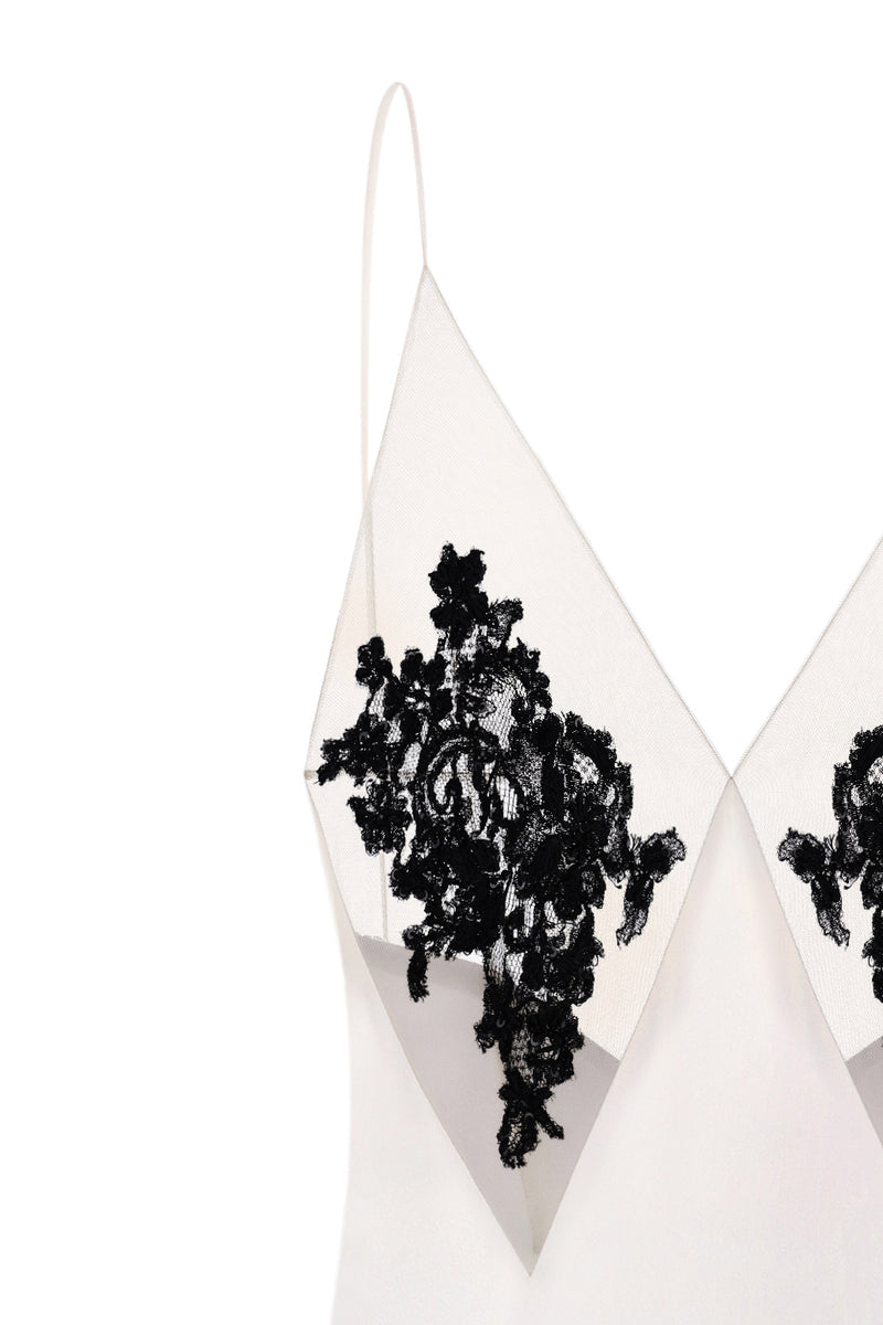 Nué Perla white maxi dress displayed on a hanger, featuring flowing fabric and elegant design ideal for summer or special occasions.