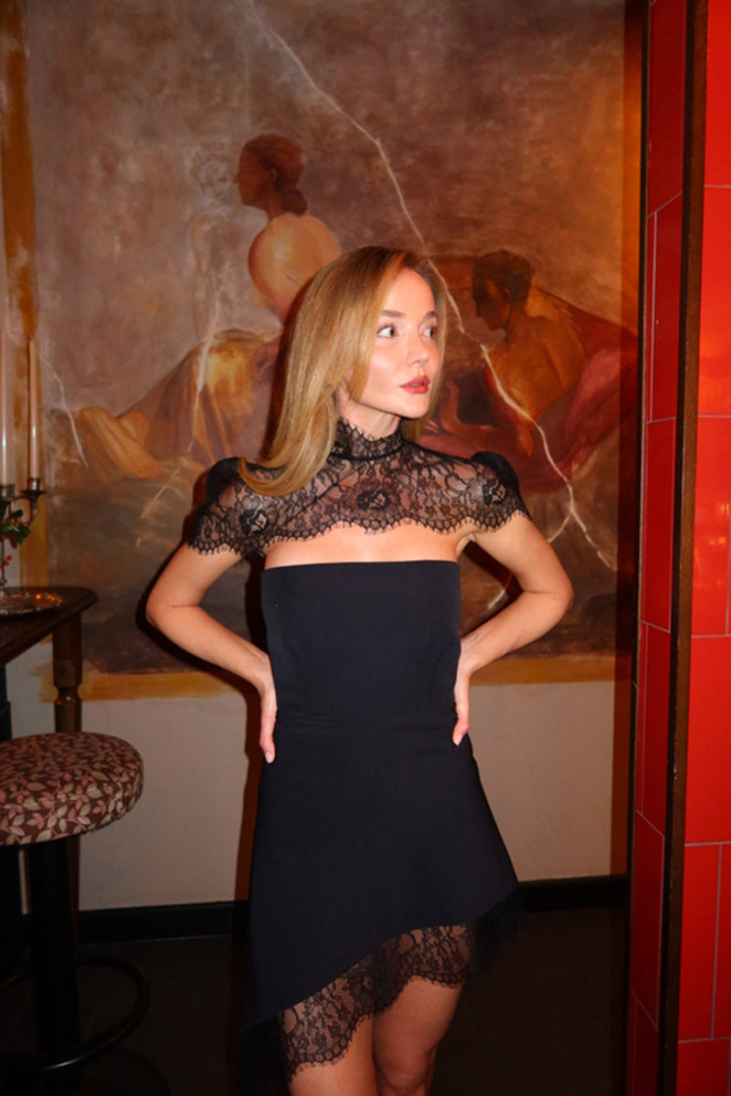 Black KATEA mini dress by MATTERS, shown on a model, featuring a fitted silhouette and elegant design.