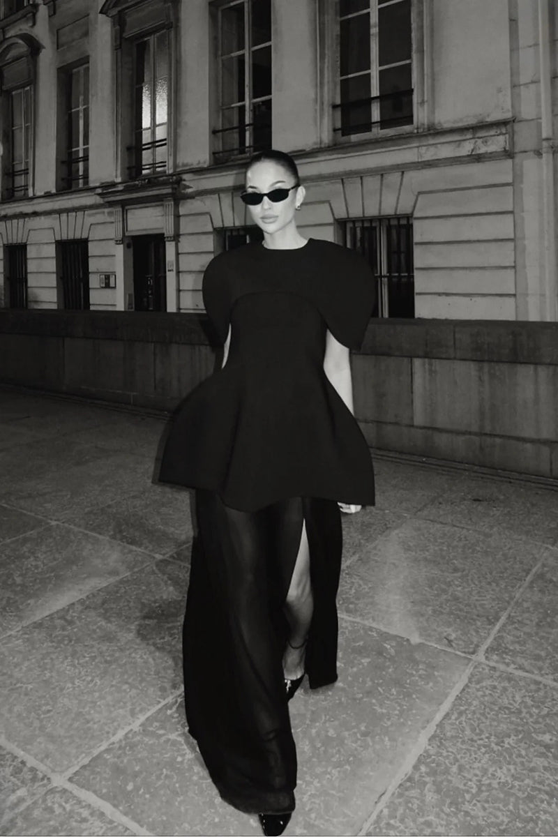 Matters Verona black gown displayed on a hanger, showcasing its elegant design and flowing fabric.
