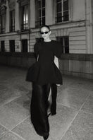 Matters Verona black gown displayed on a hanger, showcasing its elegant design and flowing fabric.
