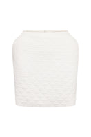White Nué Margot mini skirt displayed on a hanger with a plain background, showcasing its sleek, fitted design.