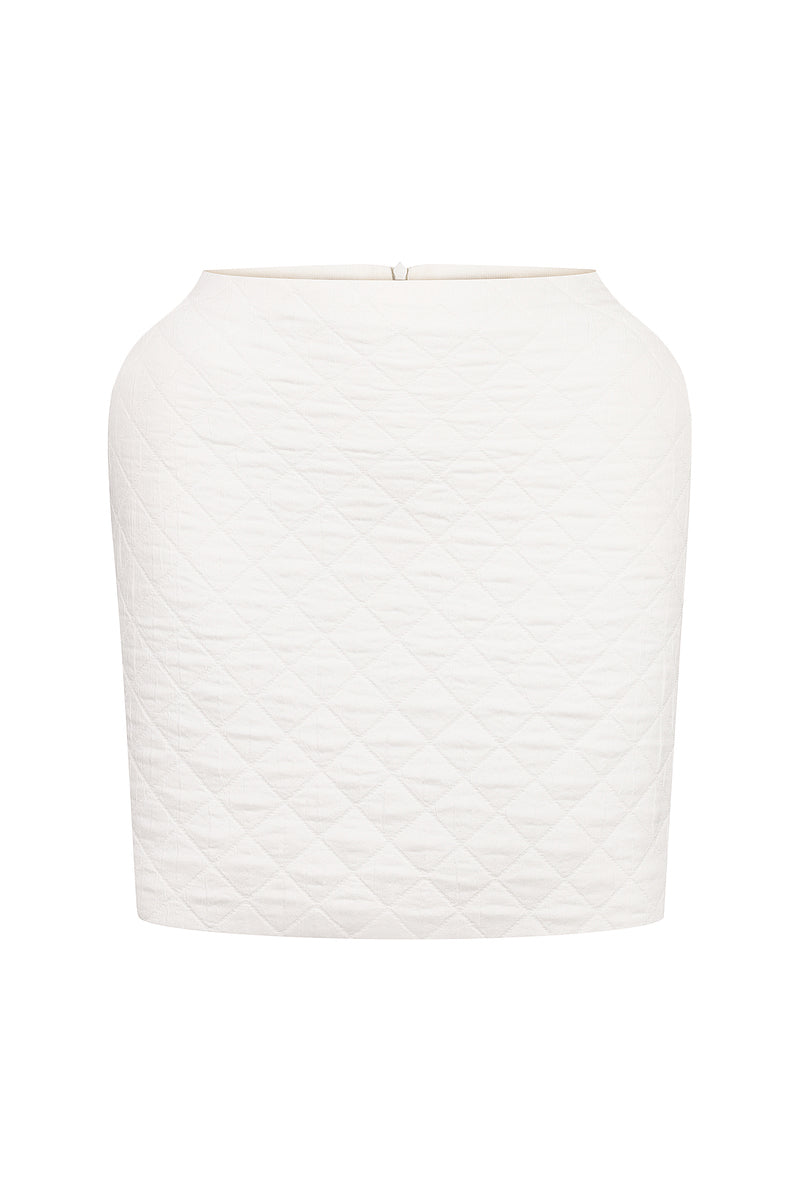 White Nué Margot mini skirt displayed on a hanger with a plain background, showcasing its sleek, fitted design.