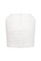 White Nué Margot mini skirt displayed on a model, showcasing its stylish design and fit.
