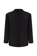 Nué Martine black blazer jacket displayed on a hanger, showcasing tailored fit and sleek design.