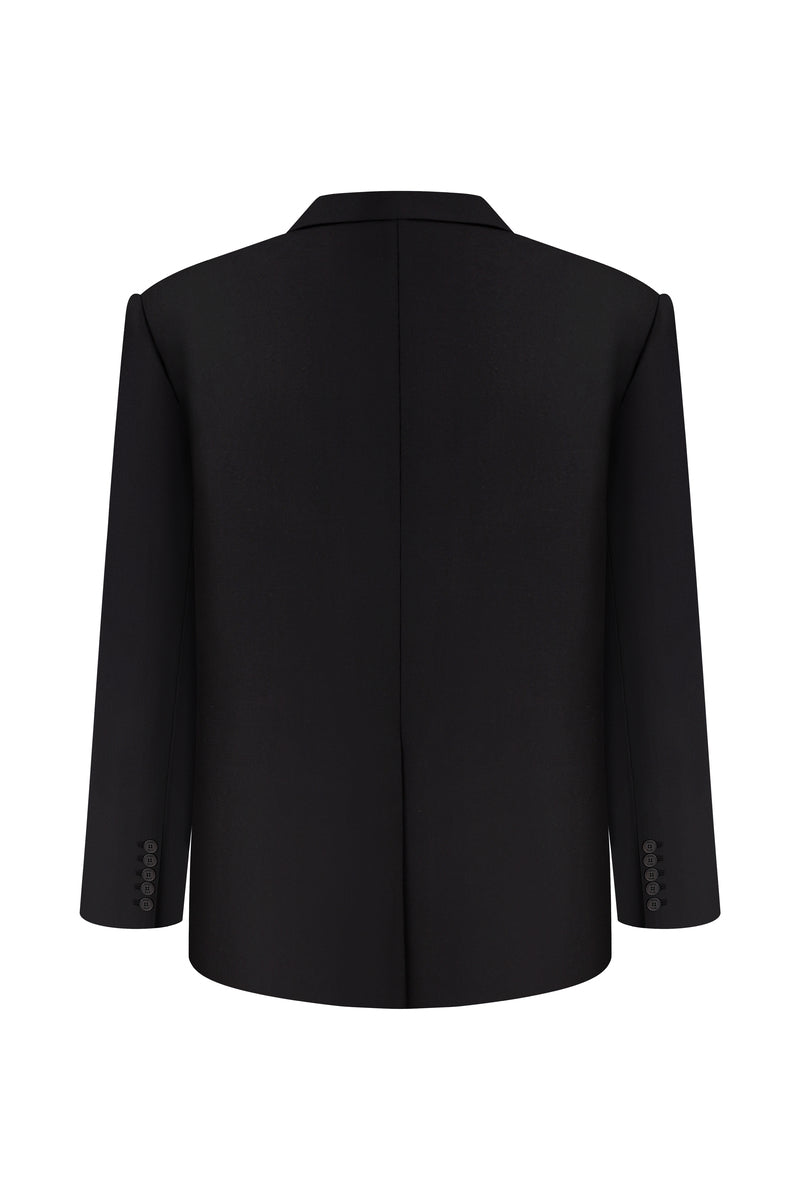 Nué Martine black blazer jacket displayed on a hanger, showcasing tailored fit and sleek design.