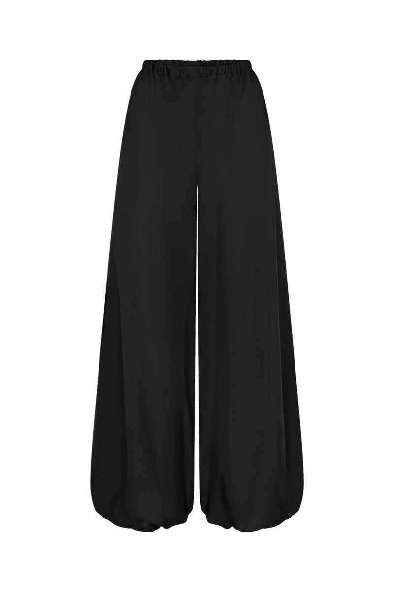 Nué Solange black pants shown, featuring a stylish fit and smooth fabric, perfect for casual or dressy occasions.