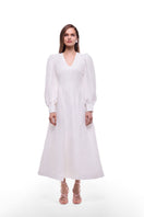 White BY HAÓ Lines structured maxi dress displayed on a hanger with intricate line details and flowing fabric.
