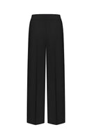 Nué Martine black pants, stylish and comfortable women's trousers, shown on a model with a focus on fit and fabric details.