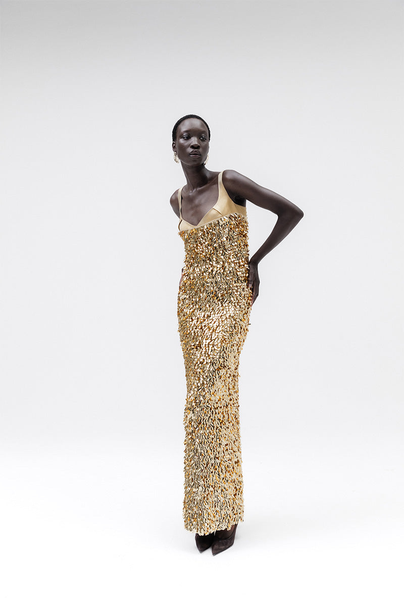Studio NK Imperial Gold gown with elegant design, featuring intricate details and a flowing silhouette perfect for formal occasions.