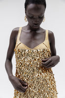 Elegant gold Imperial gown by Studio NK featuring intricate details and flowing fabric, perfect for formal occasions.