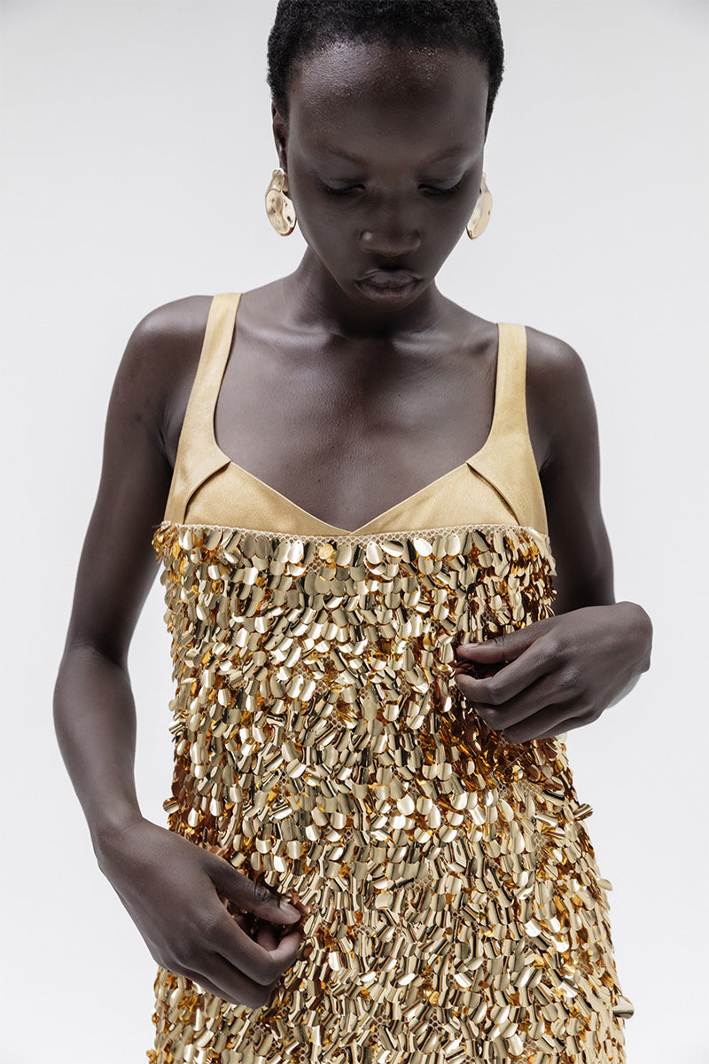 Elegant gold Imperial gown by Studio NK featuring intricate details and flowing fabric, perfect for formal occasions.