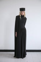 Black Infinity Dress by Studio NK, a versatile maxi dress with elegant draping and flowing fabric for stylish wear.