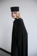 Black infinity dress by Studio NK, a versatile maxi dress with a flowing silhouette, shown in a stylish, elegant fabric.
