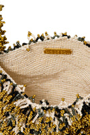 Inside view of SAC DE SOUL Nina top handle bag in white, black, cream, and gold with compartments and elegant details.