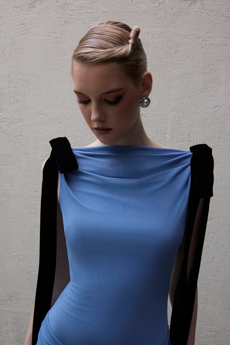 Jenny K Tran Islington dress in blue, elegant gown with a flowing silhouette, showcased in this image.