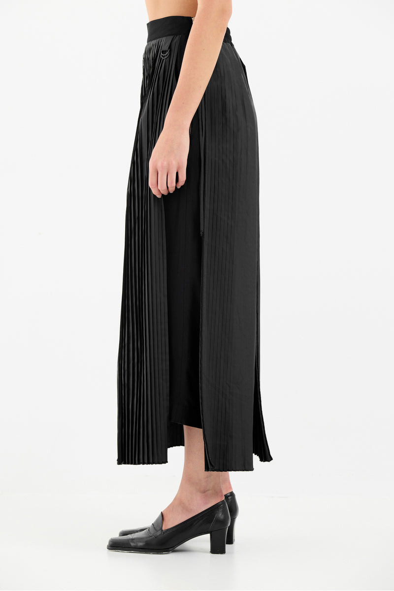 Tamar Keburia black culottes pants with wide-leg design, high waist, and tailored fit, shown on a model.