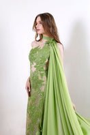 Rayane Bacha Idalia gown in vibrant green, flowing fabric with elegant design and intricate details, perfect for formal occasions.
