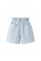 Light blue ANA + MARIA ILLA shorts with a relaxed fit, displayed on a model against a neutral background.