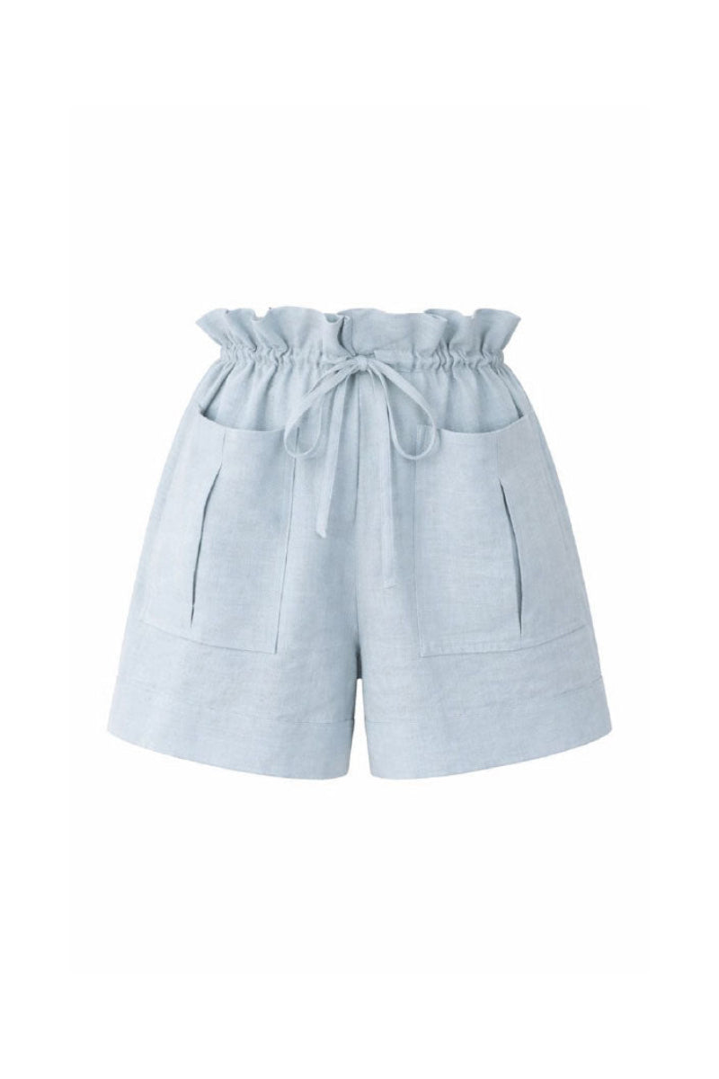 Light blue ANA + MARIA ILLA shorts with a relaxed fit, displayed on a model against a neutral background.