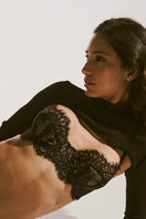Black strapless sexy bra by Ellipse Lingerie with smooth cups and supportive design, shown on a model.