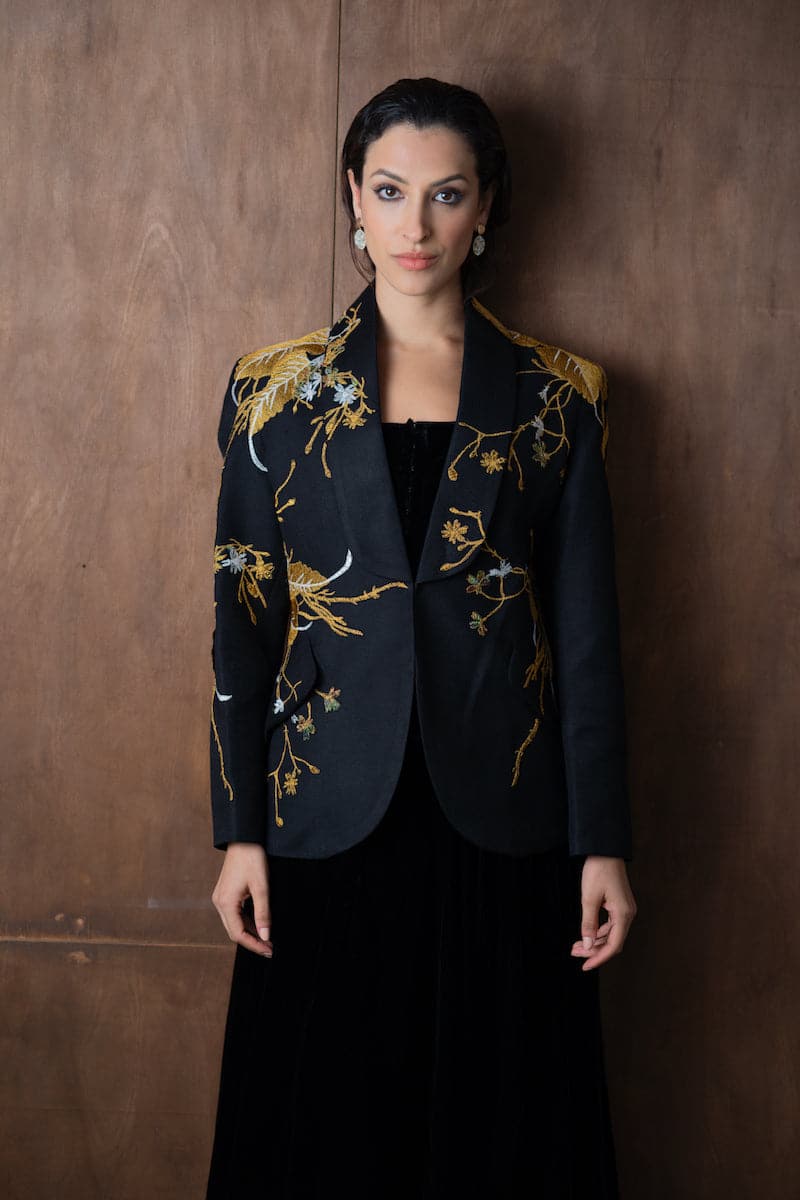 Nadya Shah Ines in the Golden Age blazer in a stylish gold-colored blazer, showing a close-up of the tailored design and fabric.