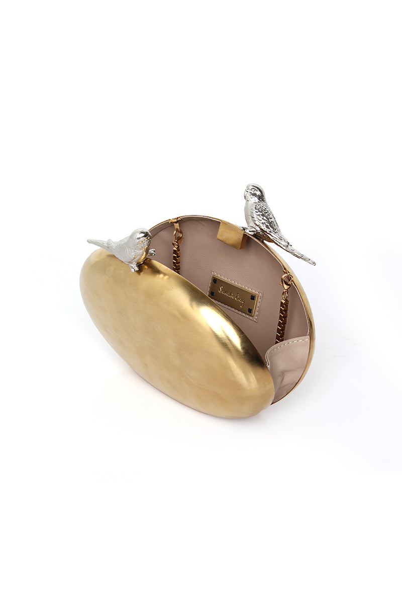 Gold clutch bag featuring an inseparable birds design by Sarah's Bag, stylish and perfect for elegant occasions.