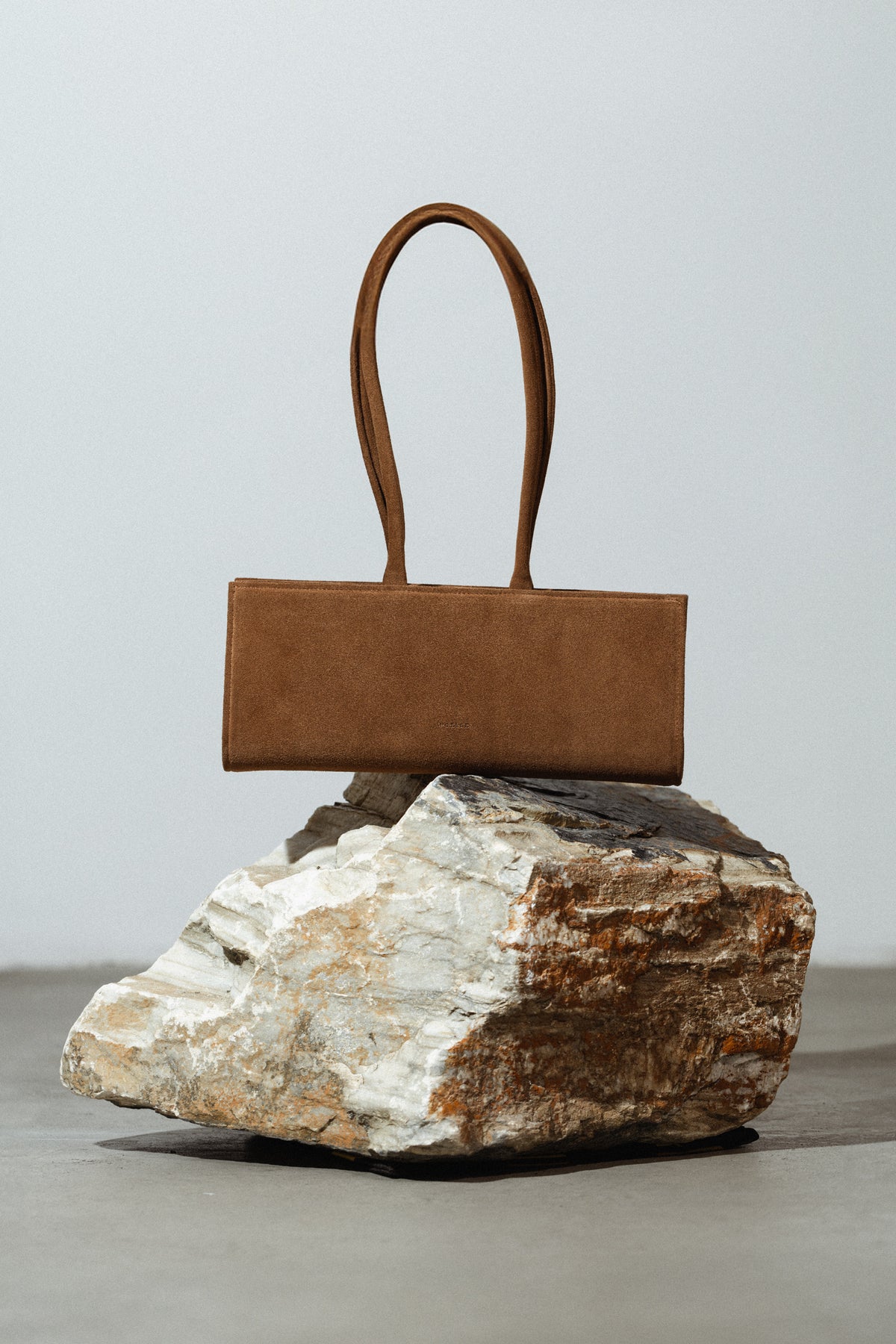 Poelle Cecilie bag in caramel, a stylish top handle bag with a sleek design, perfect for everyday use.