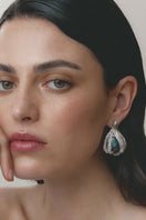 Rhodium-plated blue interchangeable loop hoops earrings by Jude Benhalim, showcasing sleek circular design with a shiny finish.
