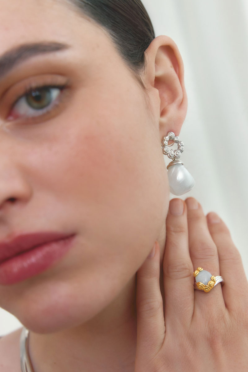 Jude Benhalim interchangeable bloom earrings featuring colorful floral designs and gold-tone hooks on a white background.