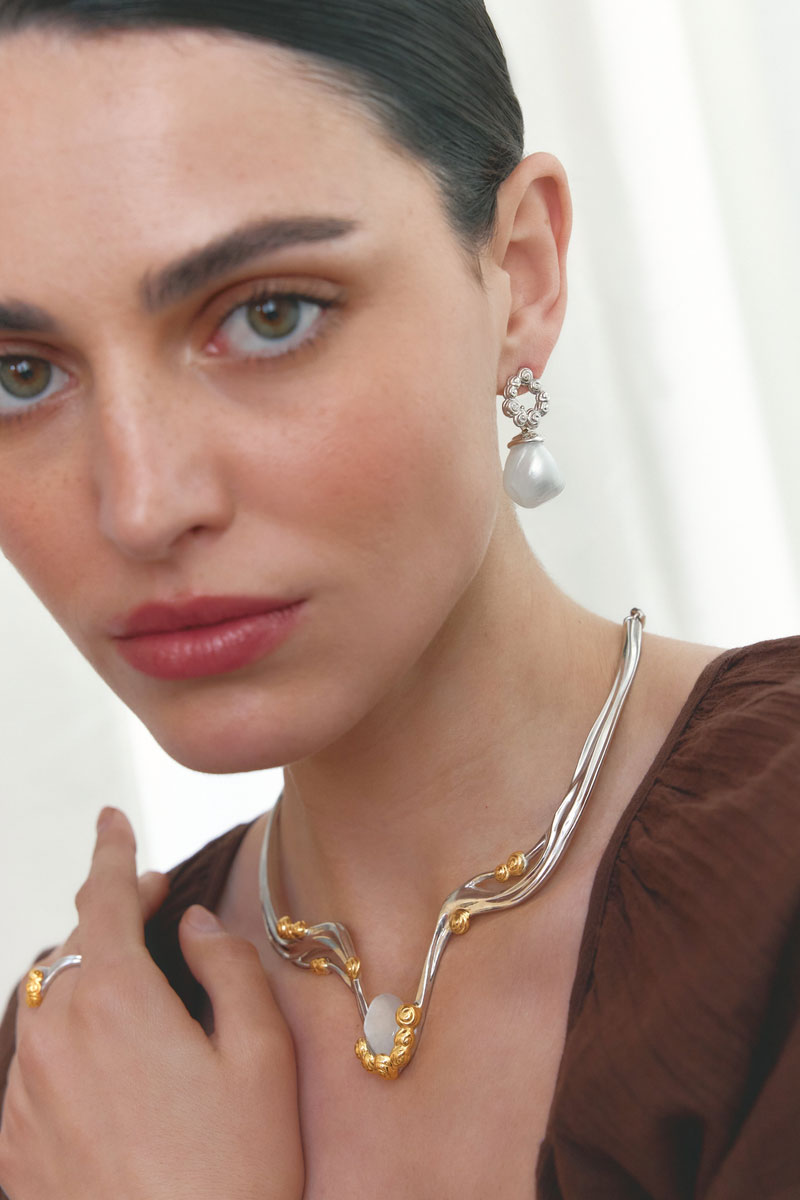 Jude Benhalim interchangeable bloom earrings featuring floral designs and multiple color options, styled on a model.