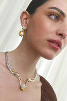 Jude Benhalim interchangeable bloom earrings featuring colorful floral designs on gold-tone metal.