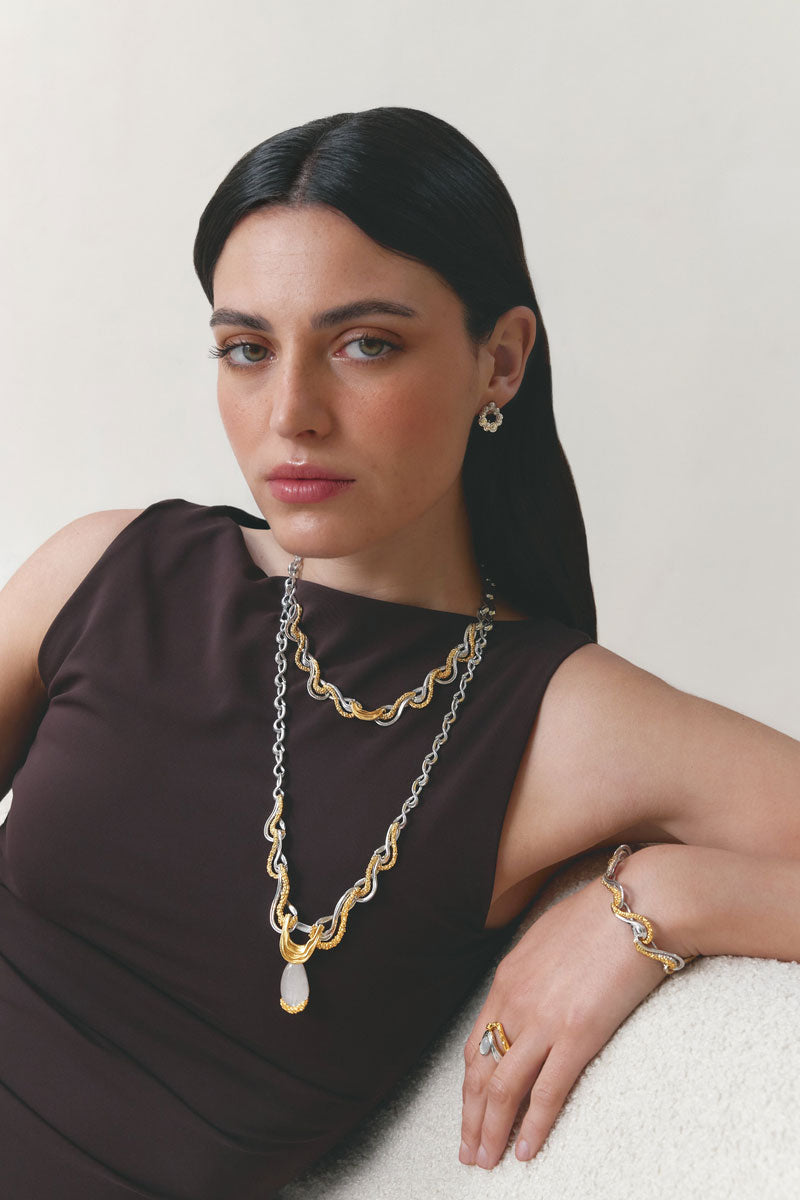 Jude Benhalim interchangeable bloom earrings featuring colorful floral designs on gold-tone metal, styled with multiple flower motifs.