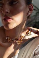 Salvára interconnection necklace in amber featuring a delicate chain with amber beads and intricate design.