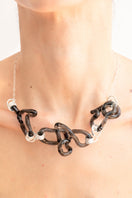 Salvárea Interconexión Necklace in smoke with layered silver chains and adjustable clasps, stylish jewelry accessory.
