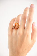 Set of SALVÁREA interconnection rings featuring amber-colored rings with intricate designs, perfect for stylish jewelry arrangements.