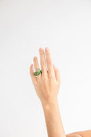 Set of green interconnection rings by SALVÁREA, showcasing multiple interconnected rings in a vibrant green color.