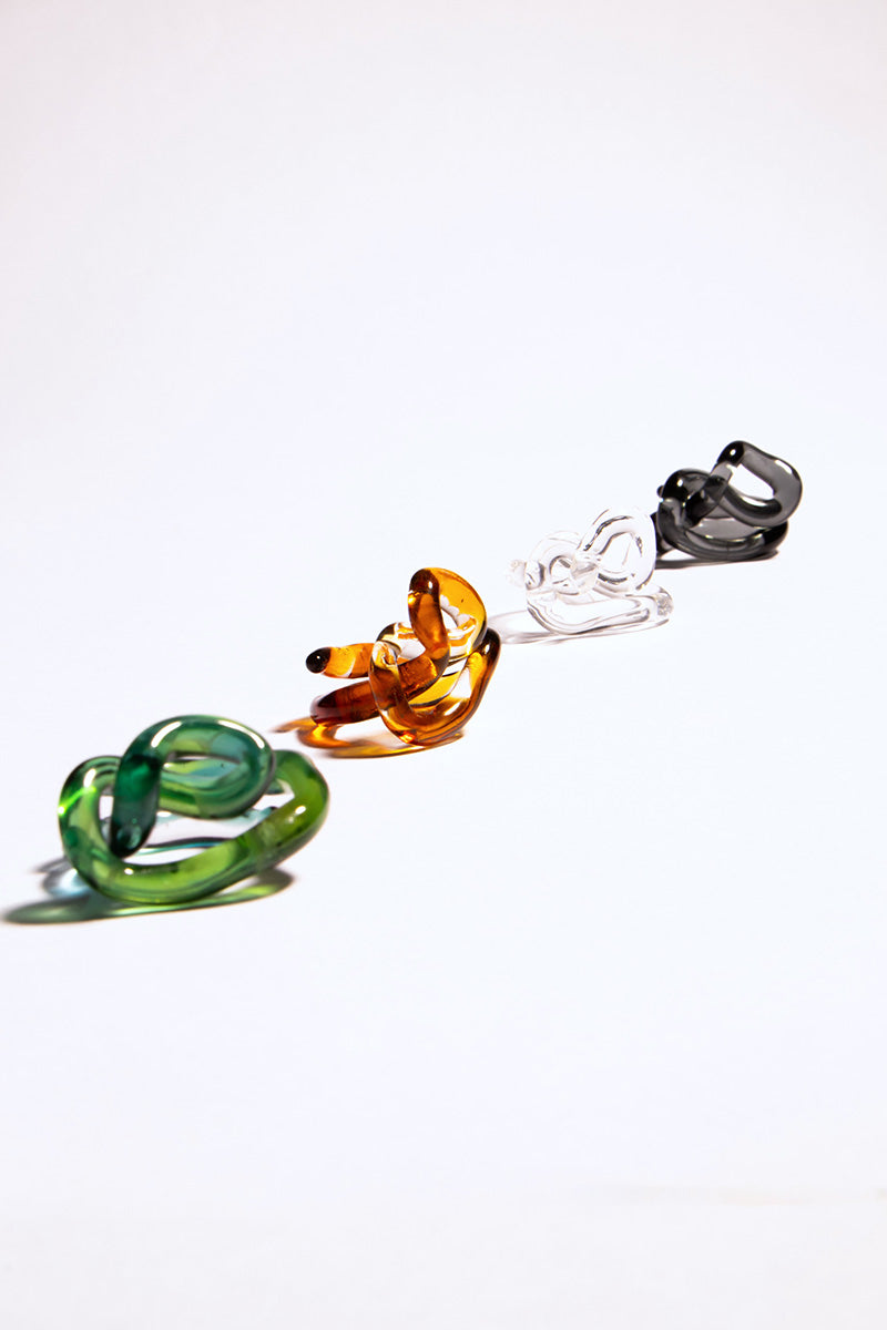Salvária interconnection rings set featuring green rings, showcasing interconnected jewelry pieces with a vibrant color.