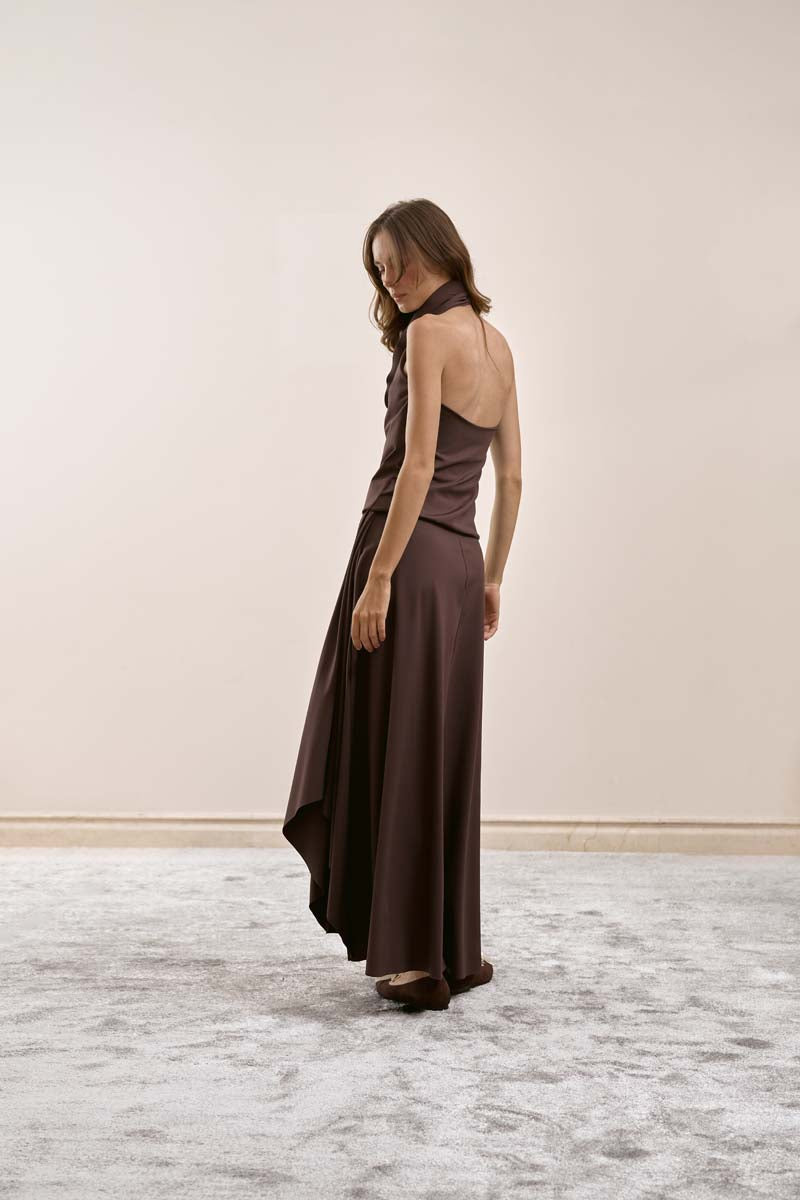 YASSMIN SALEH brown intersect midi skirt shown from a side view, featuring a stylish and modern design ideal for casual or dressy wear.