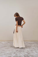 YASSMIN SALEH white intersect midi skirt displayed from the back, featuring a sleek ivory design and modern silhouette.