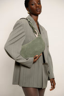 Olive green suede Amalfi shoulder bag by Isidora Malva, featuring a stylish design with a shoulder strap and textured finish.