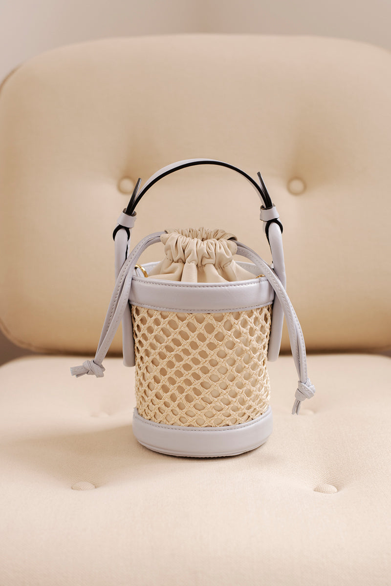 Blue IZA bucket top handle bag by Isidora Malva with a structured shape and stylish design, shown with the bag's front view.