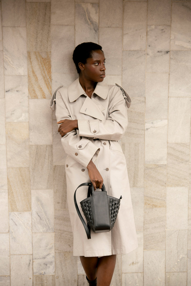 Black Isidora Malva La Dorada Mini top handle bag with sleek design and structured shape, shown from a front view.