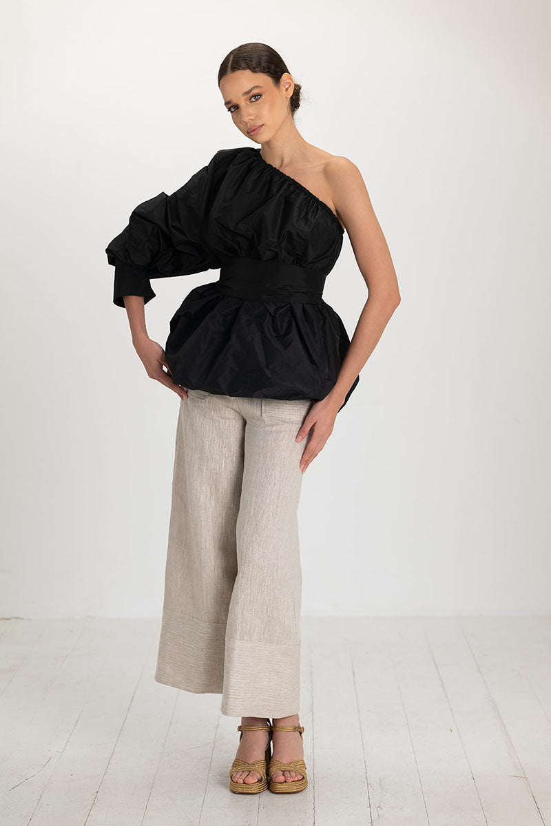 Black Isolde top by ANA + MARIA, featuring a fitted design and short sleeves, displayed on a neutral background.