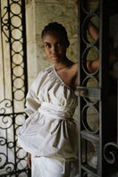 ANA + MARIA Isolde top in smoke gray, stylish sleeveless blouse with a relaxed fit, shown in a campaign photo.