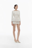 Ivory brocade blazer from Montsand, stylish with intricate woven pattern, paired with matching skirt for elegant formal wear.
