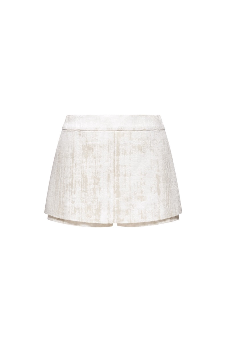 Ivory brocade mini skirt by Montsand featuring intricate floral patterns and a fitted waistband.