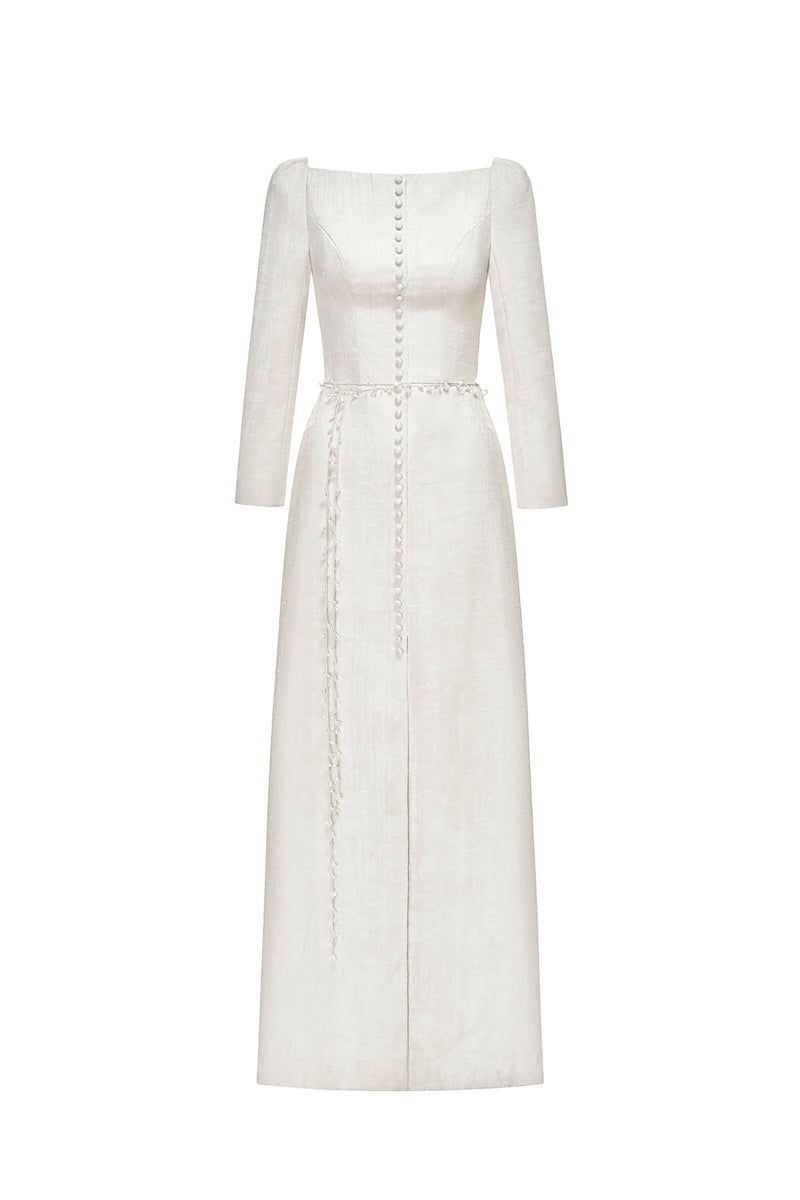 Ivory brocade split maxi dress by Montsand featuring elegant floral pattern and flowing silhouette on a model.
