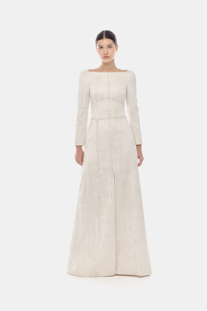 Ivory brocade split maxi dress by Montsand featuring elegant fabric and a flowing silhouette for formal occasions.